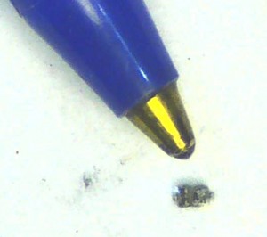 The jumper which I removed from the radio, compared to the tip of a ballpoint pen.